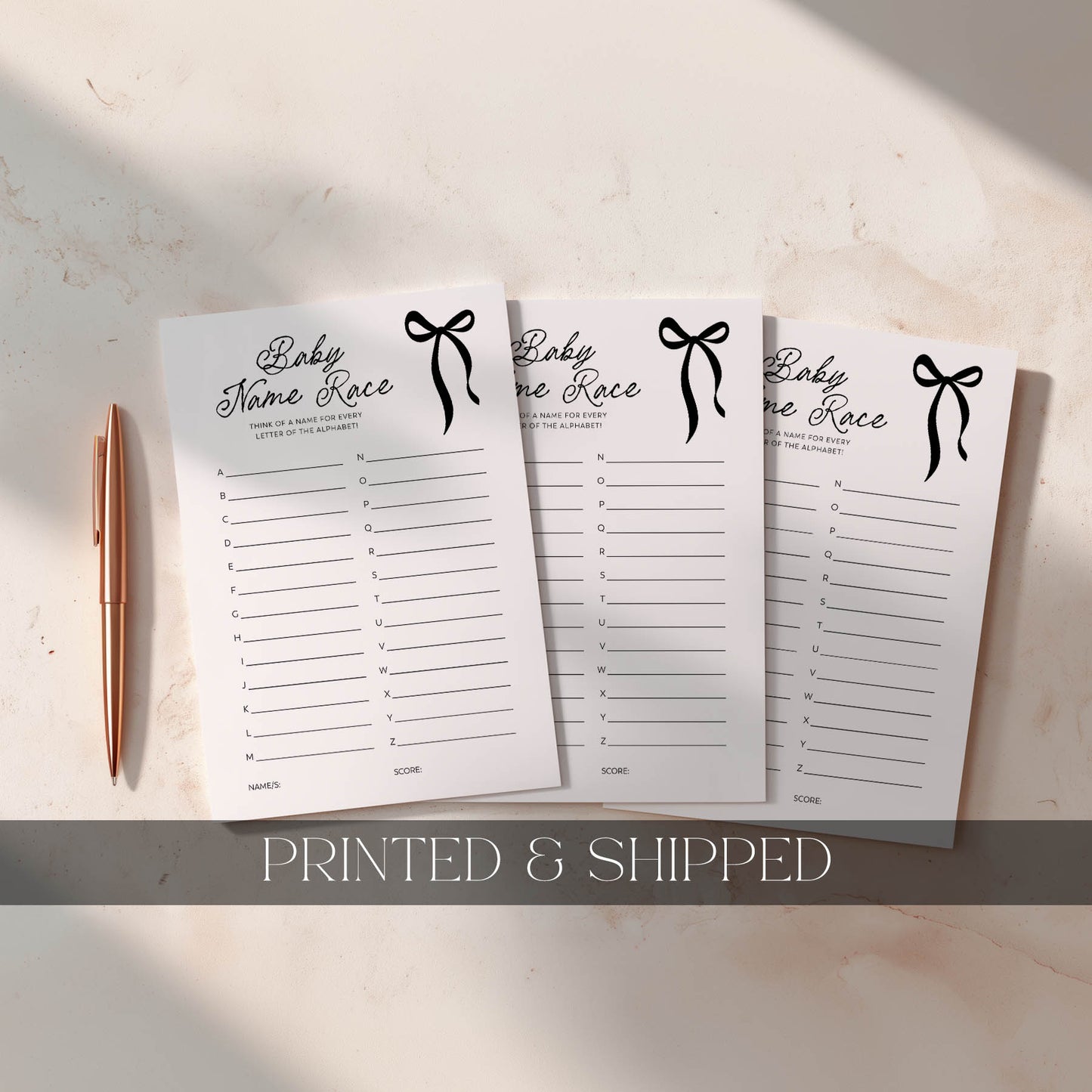 Three black bow printed baby name race sheets with a pen on a light surface, labeled 'Printed & Shipped'.