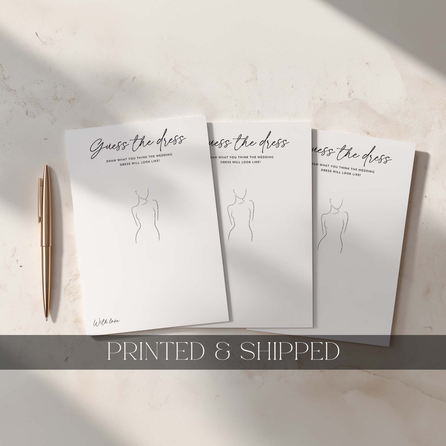 Three 'Guess the dress' cards with a pen on a light surface