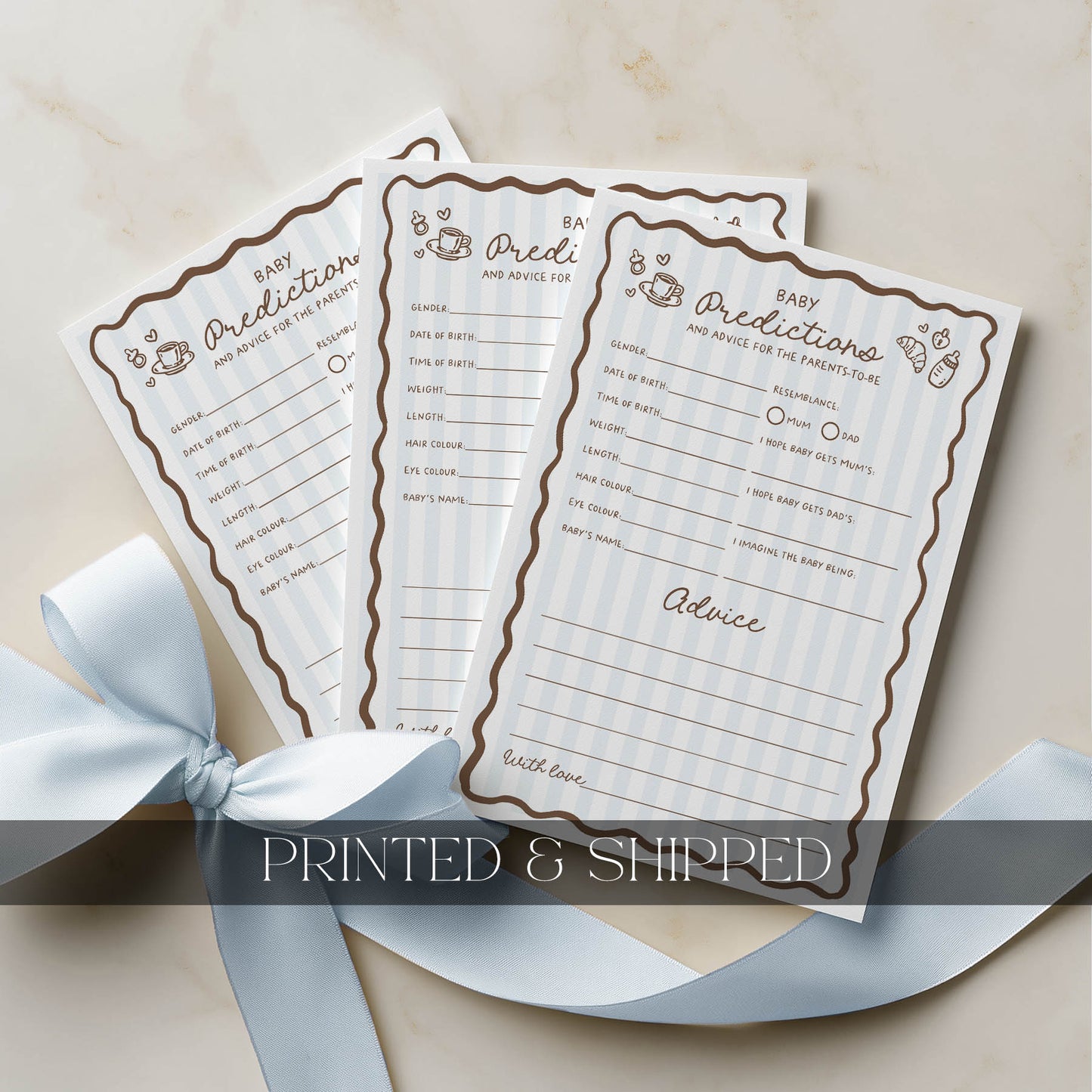 Three baby prediction and advice cards with decorative ribbon on a beige background