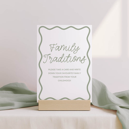 Card with 'Family Traditions' text on a stand with light green fabric in the background