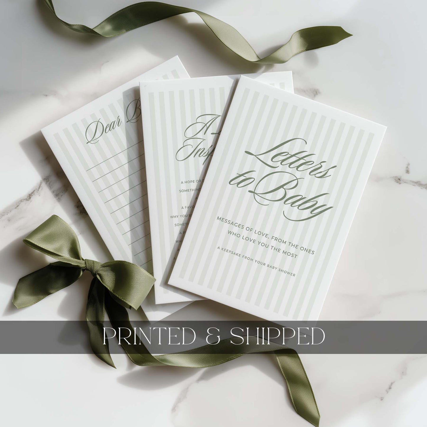 Set of 'Letters to Baby' books with green stripe ribbons on a light background