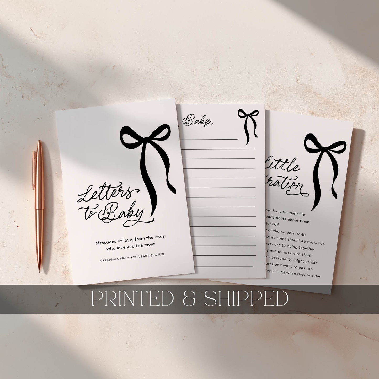 Set of three notebooks with black bow designs and text on a light surface, accompanied by a pen.