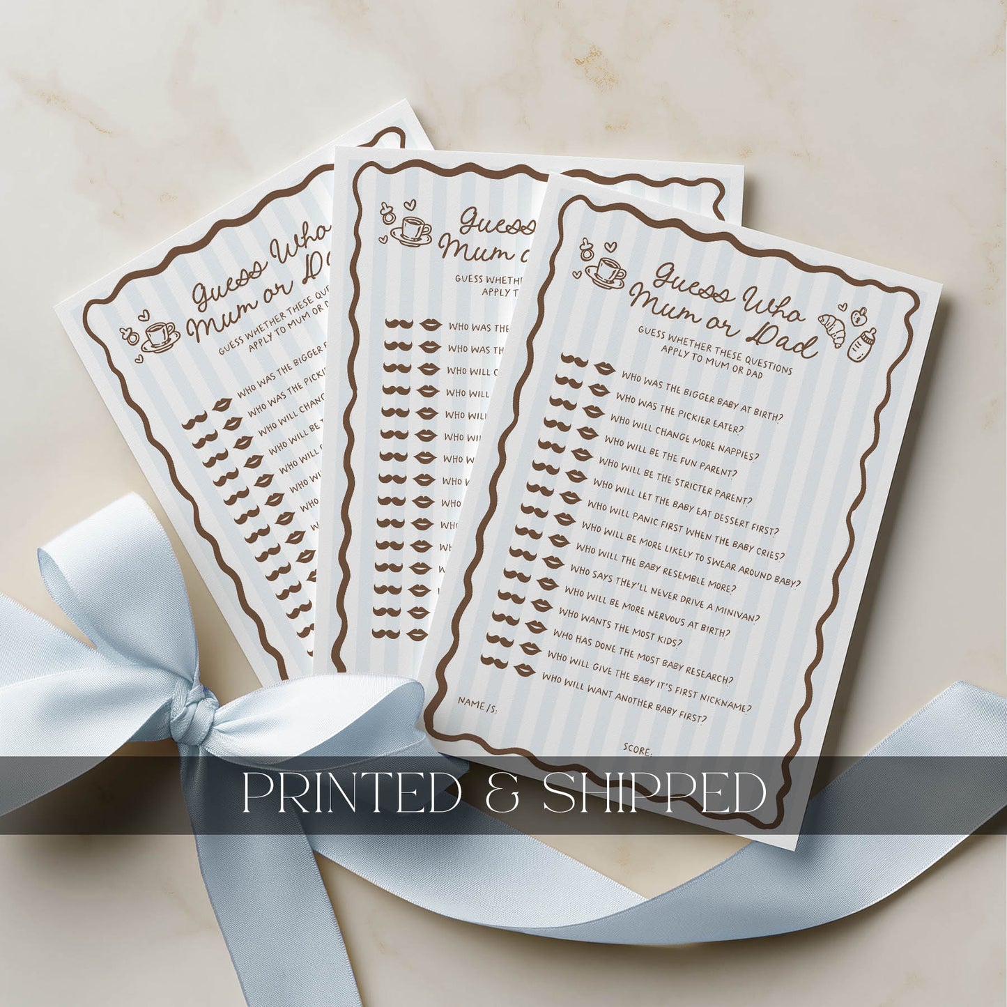 Two baby shower game cards withGuess Who? Mum or Dad text, surrounded by a white ribbon on a beige background.