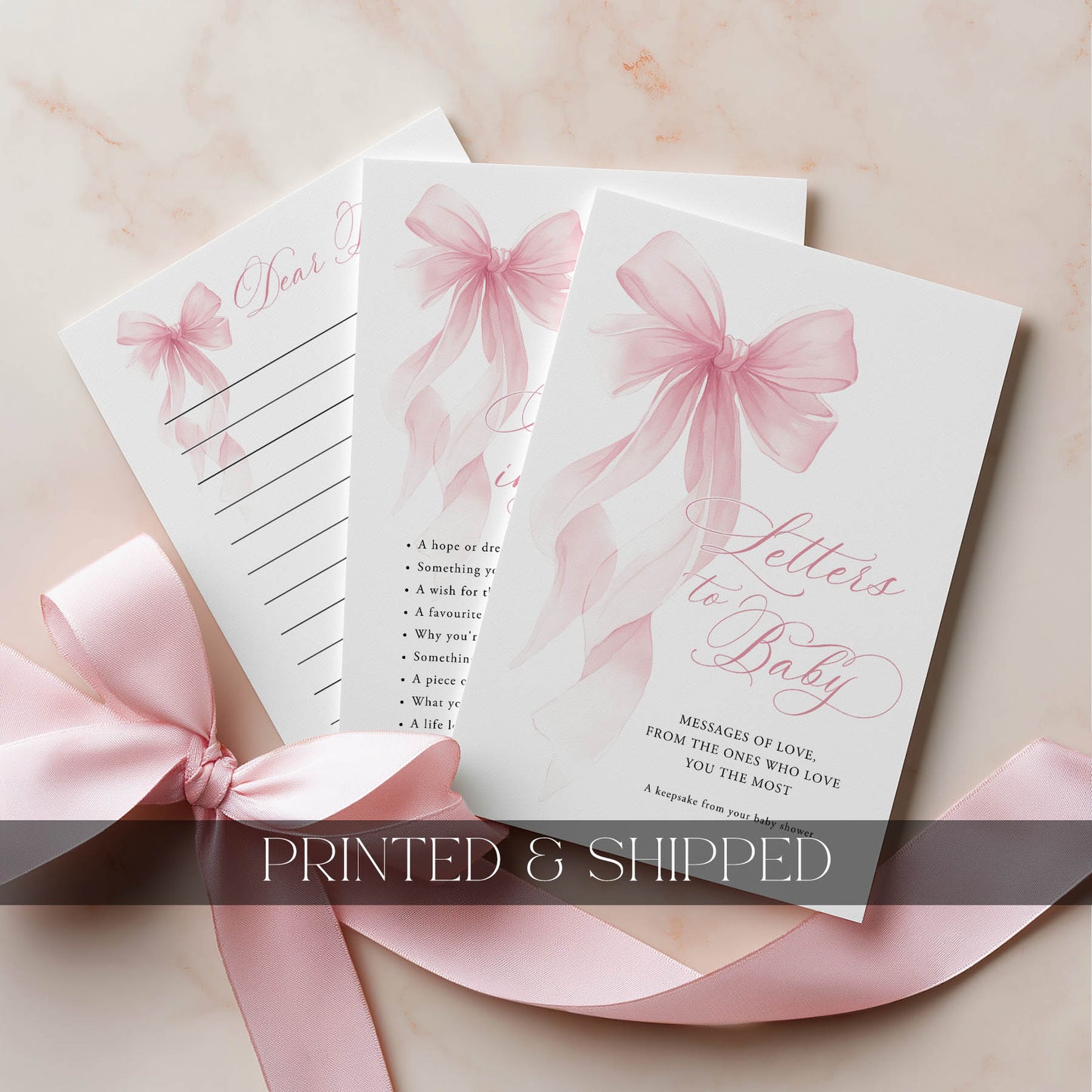 Set of baby shower cards with a pink checkered design and a pink ribbon on a light background.