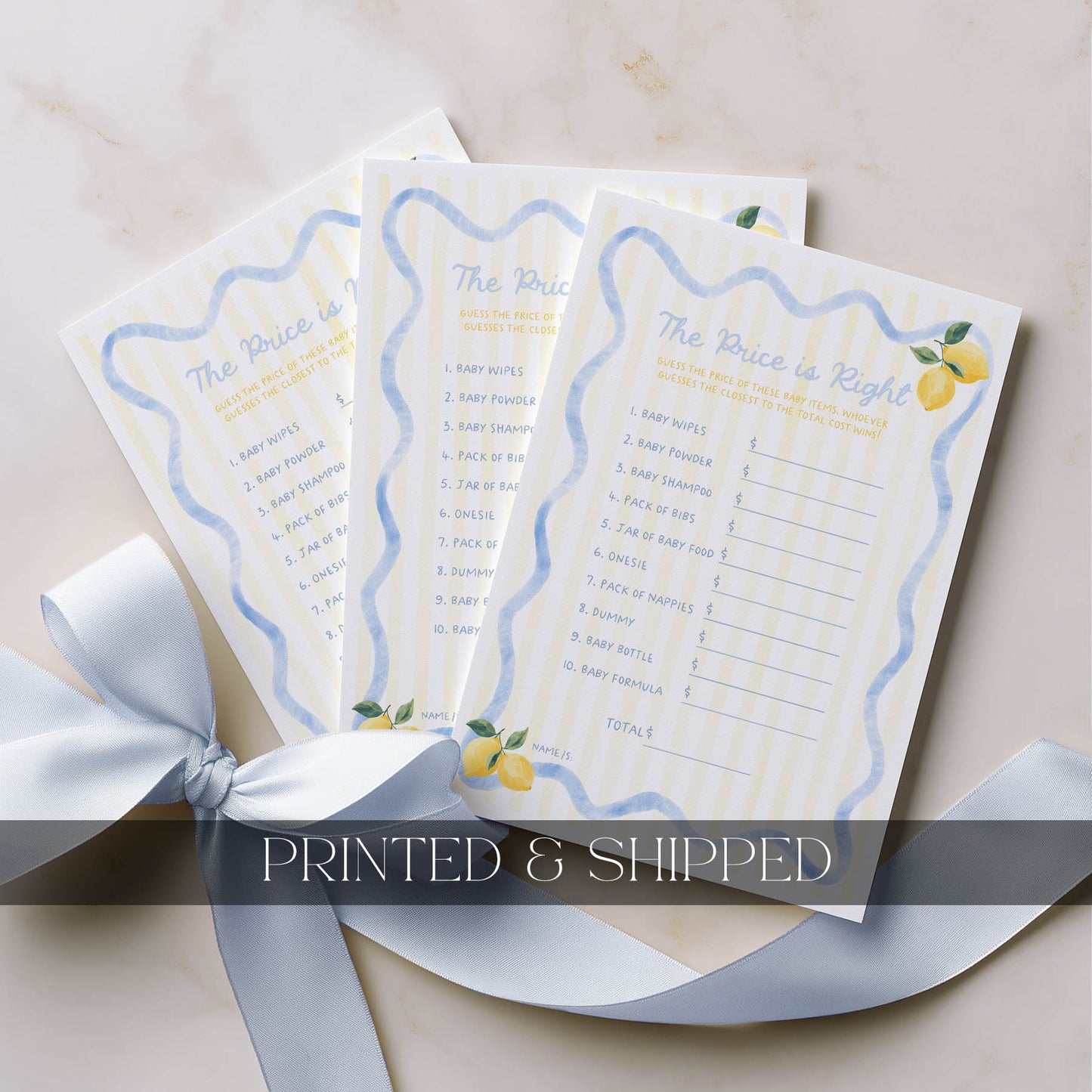 Three 'The Price is Right' game sheets with lemon illustrations on a beige surface with a white ribbon.