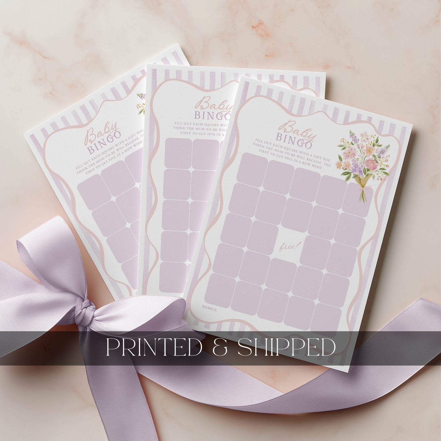 Baby bingo cards with a ribbon on a light background