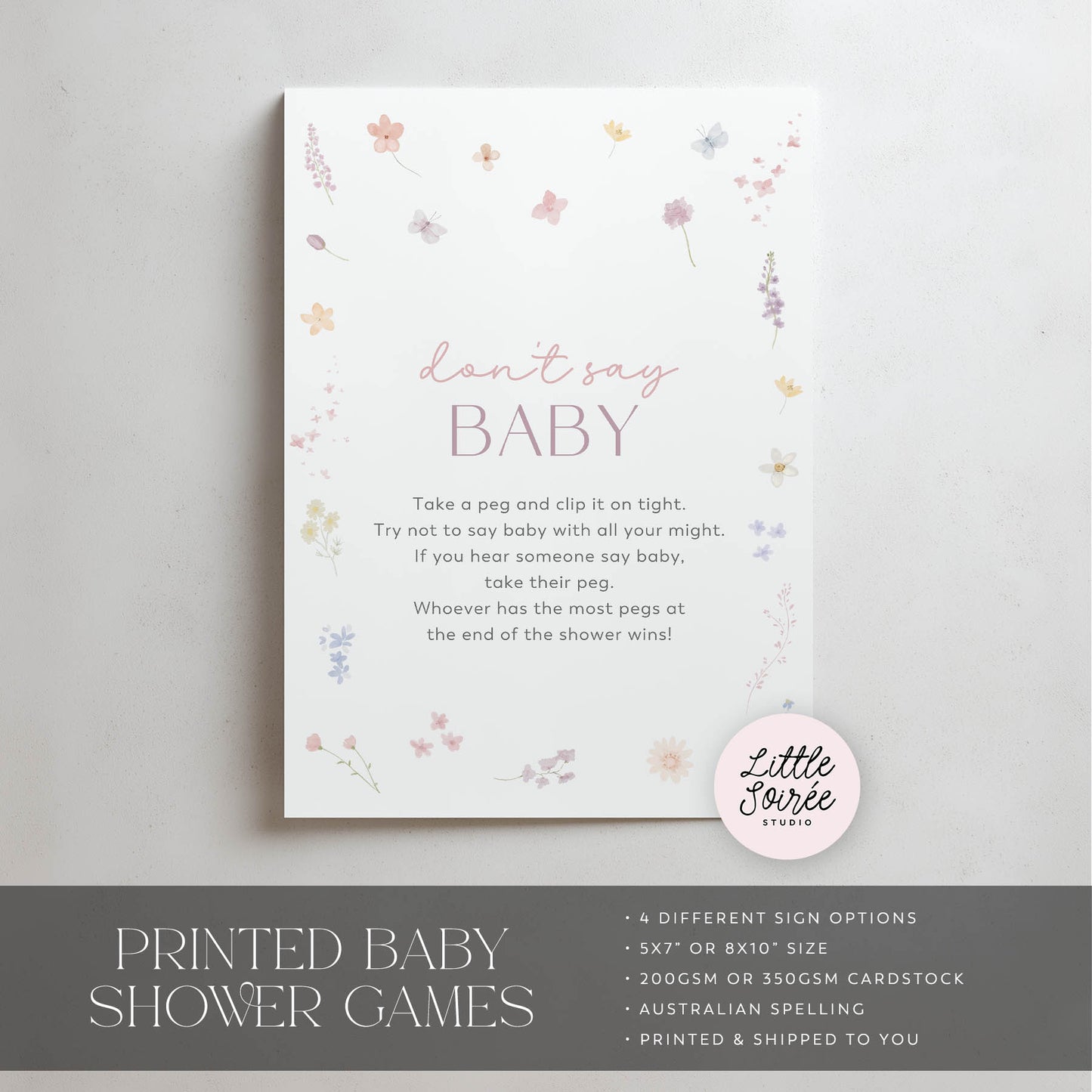 Baby shower game sign with floral design and text on a gray background