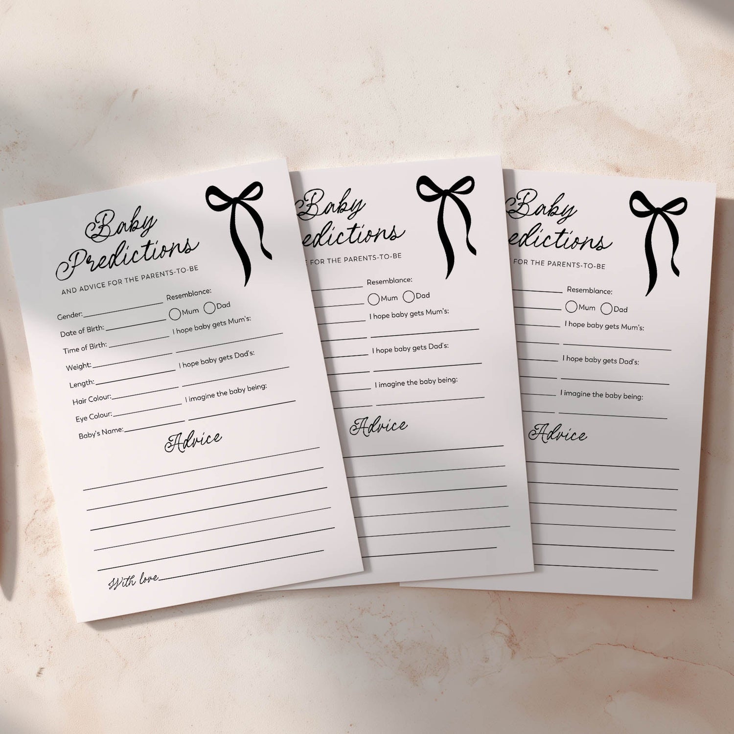 three a5 cards with black bow and baby predictions written in script font