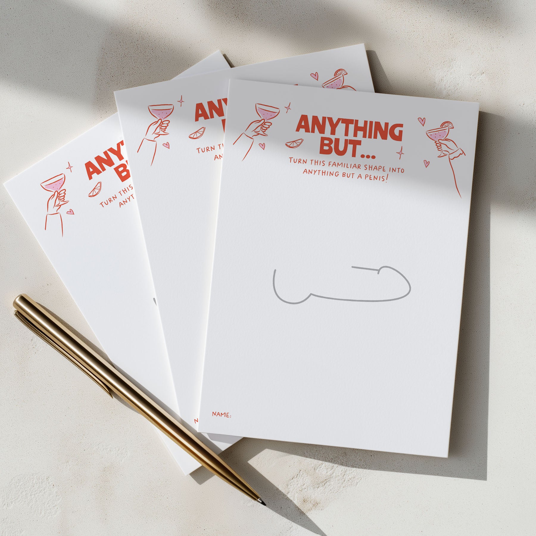 Three hens party game sheets fanned out on a light surface, printed with the phrase 'ANYTHING BUT.