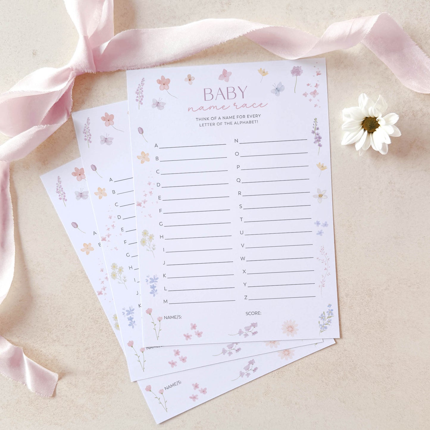 Baby shower game sheets with decorative elements on a light background