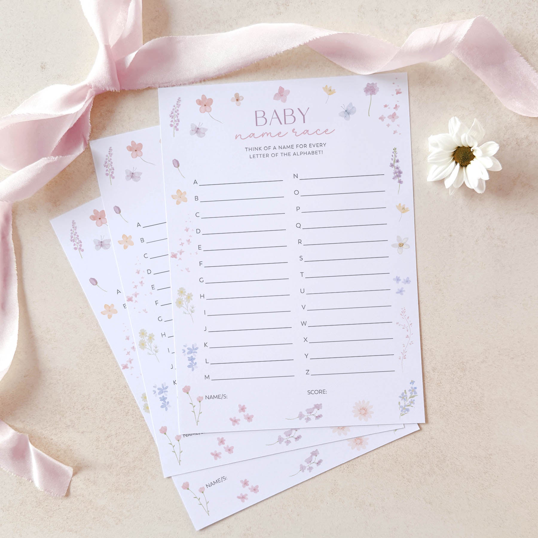 Baby shower game sheets with decorative elements on a light background