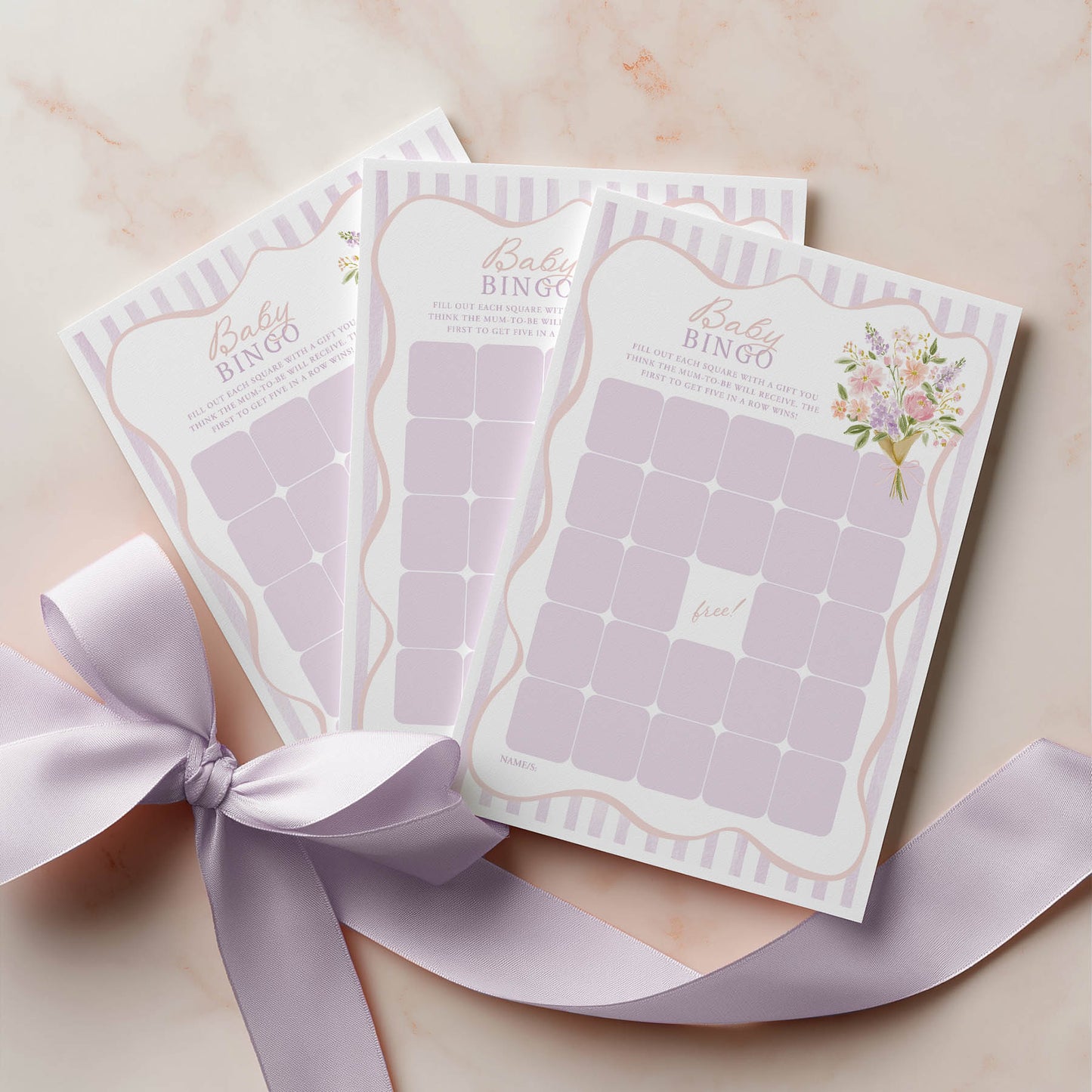 Baby bingo cards with a ribbon on a light background