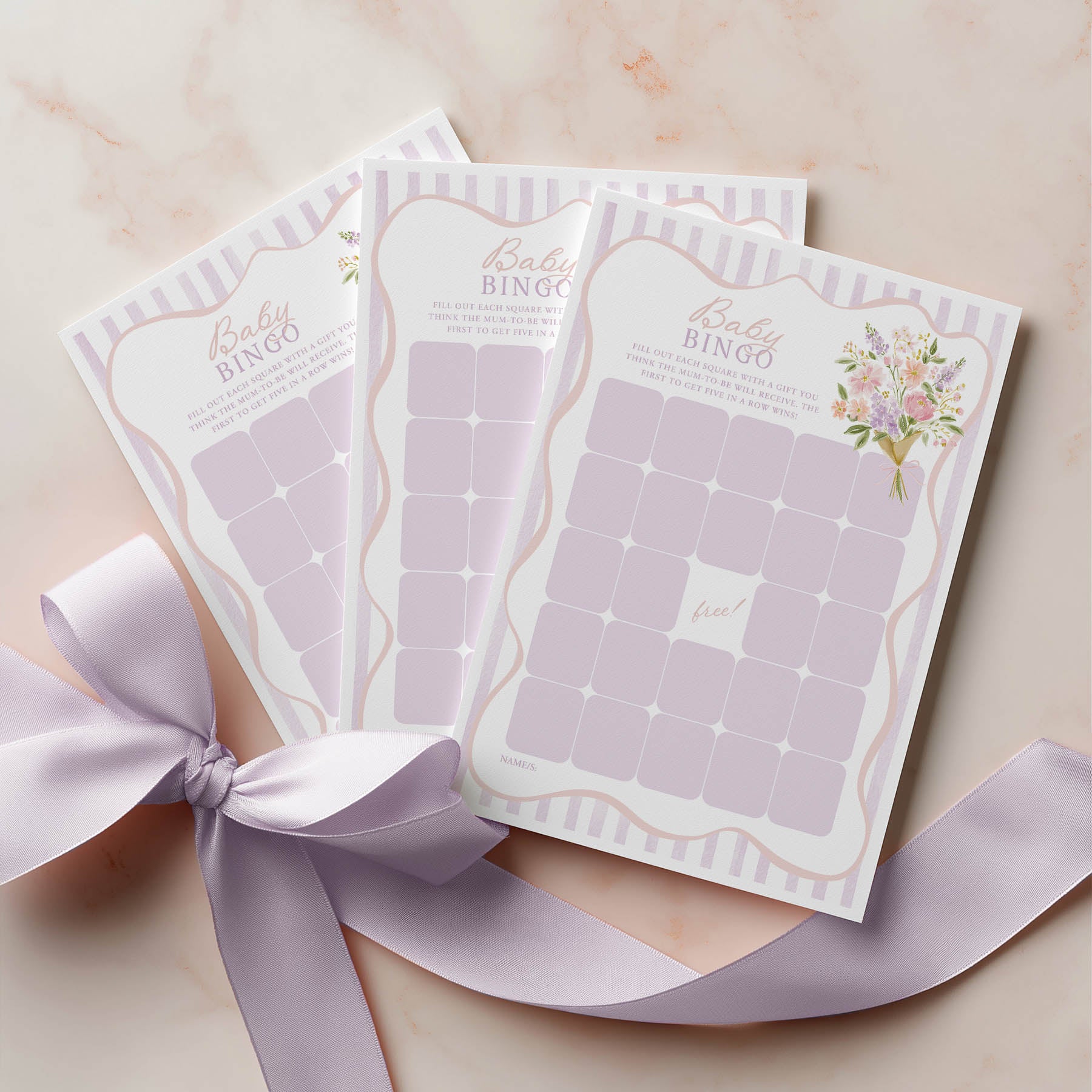 Baby bingo cards with a ribbon on a light background