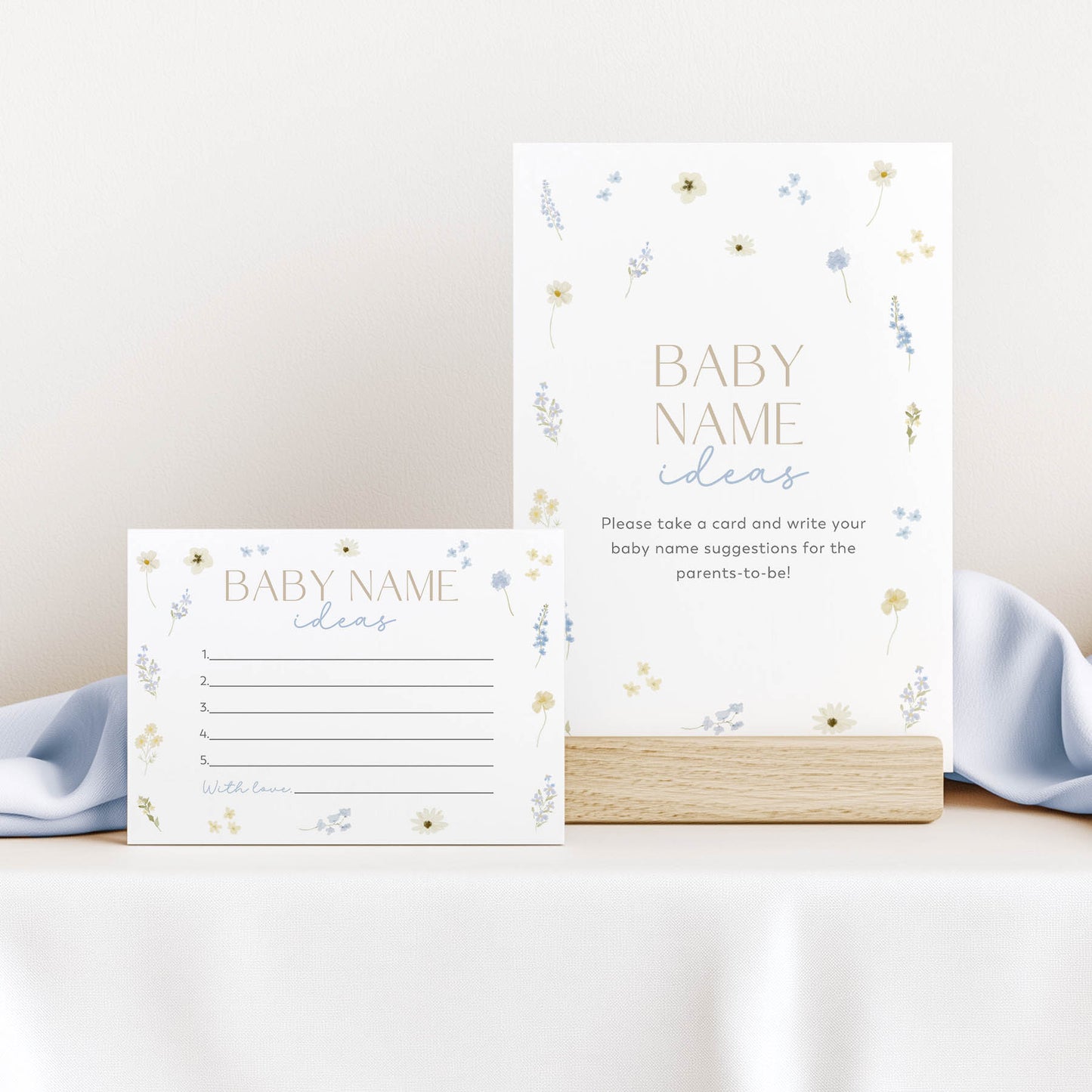 Two baby name suggestion cards with floral designs on a white surface.