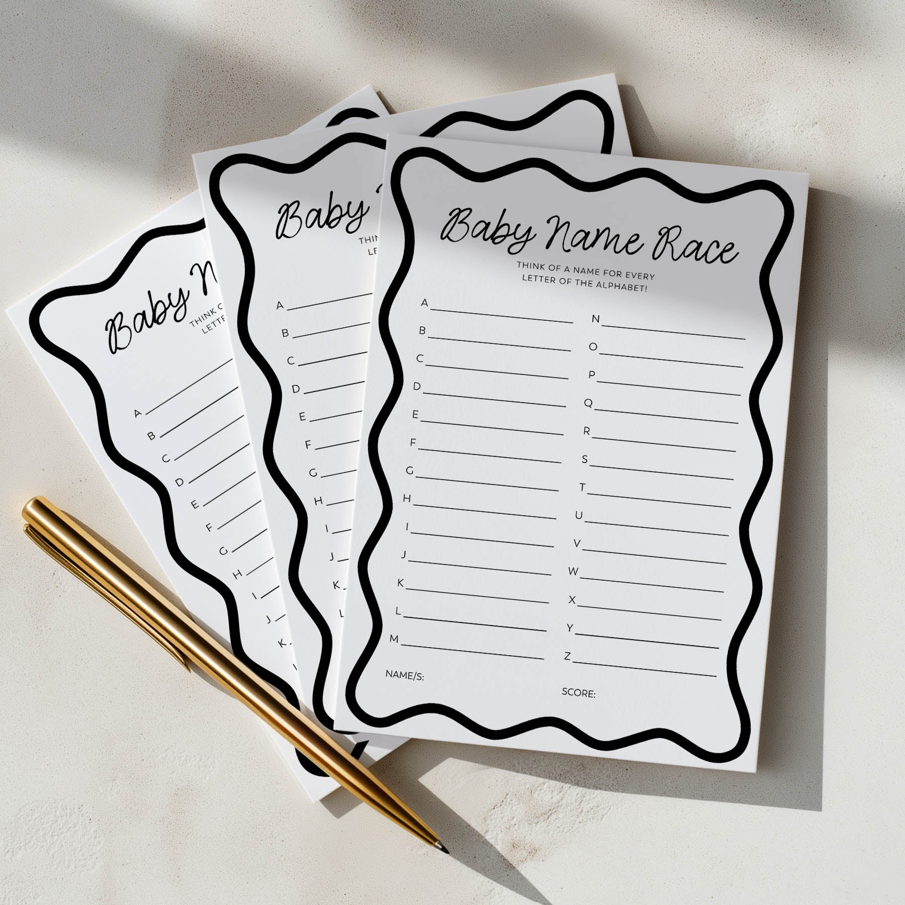 Three sheets of paper with 'Baby Name Race' game on a light surface with a pen.