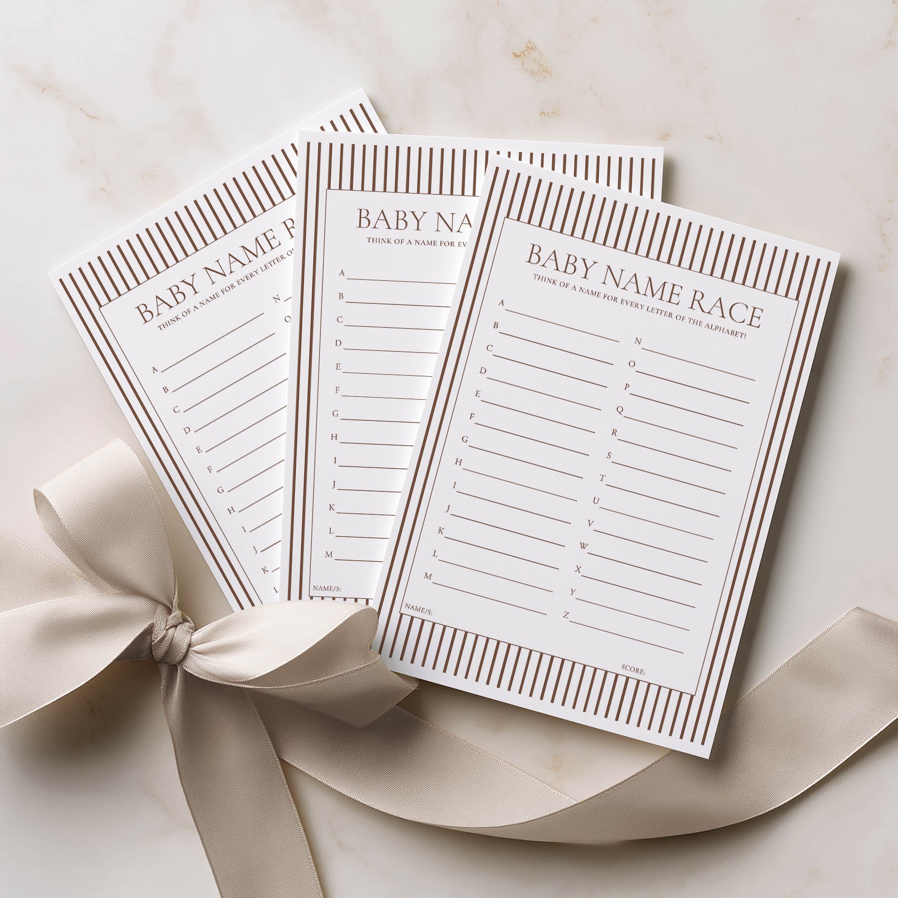 Three baby name race cards with a ribbon on a light background