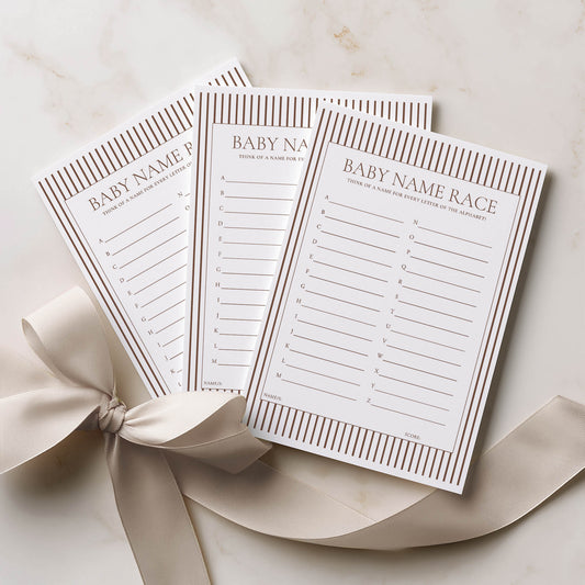 Three baby name race cards with a ribbon on a light background