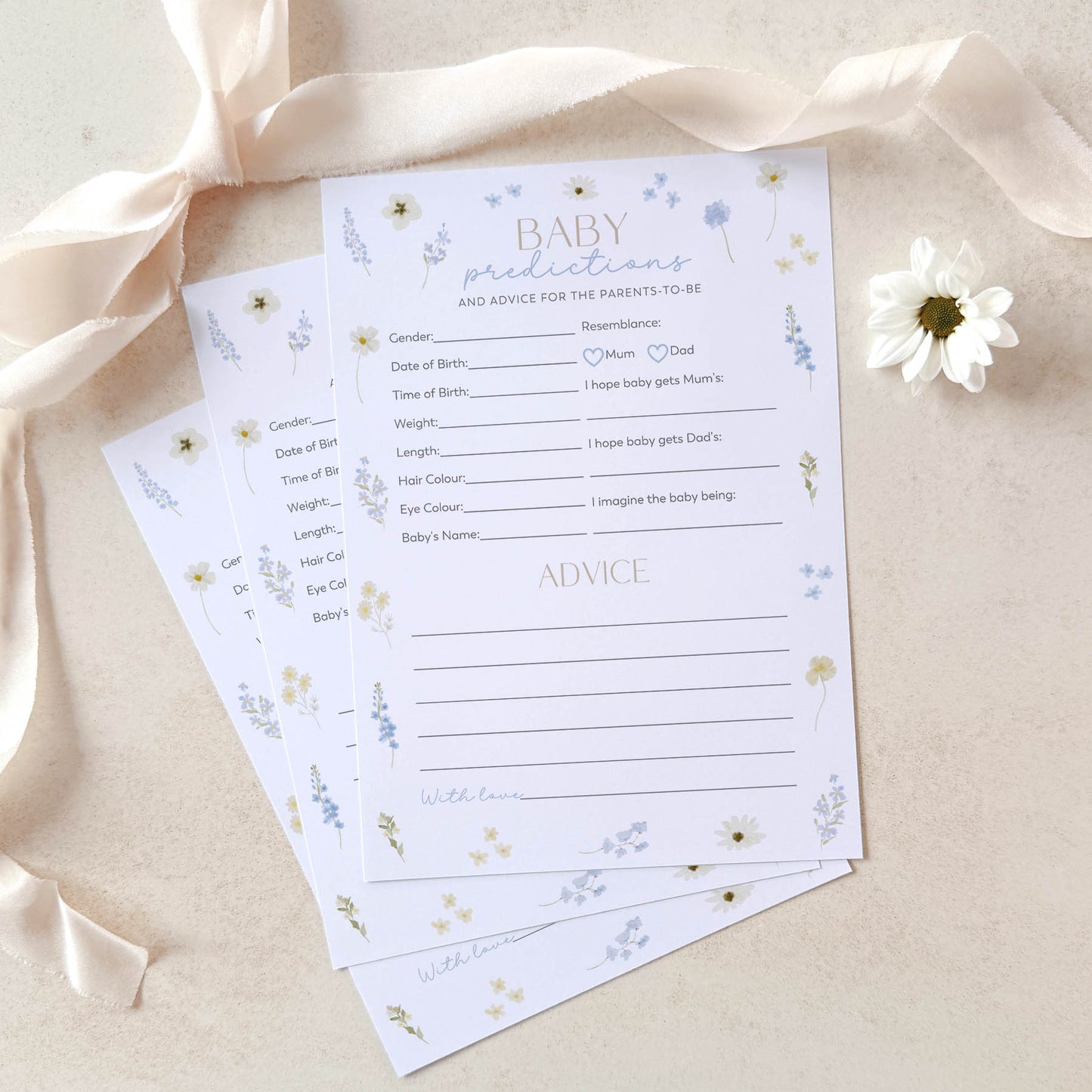 Baby shower prediction and advice cards with floral design on a beige background