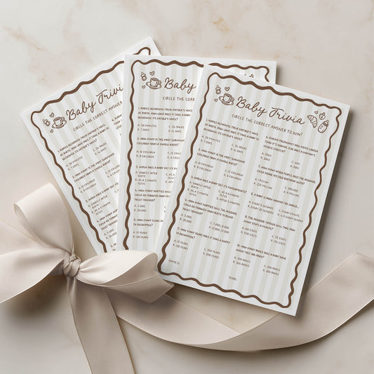 Three baby trivia cards with decorative borders on a beige background