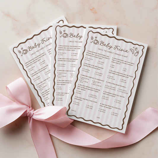 Two baby trivia cards with decorative border on a light pink background with a pink ribbon.
