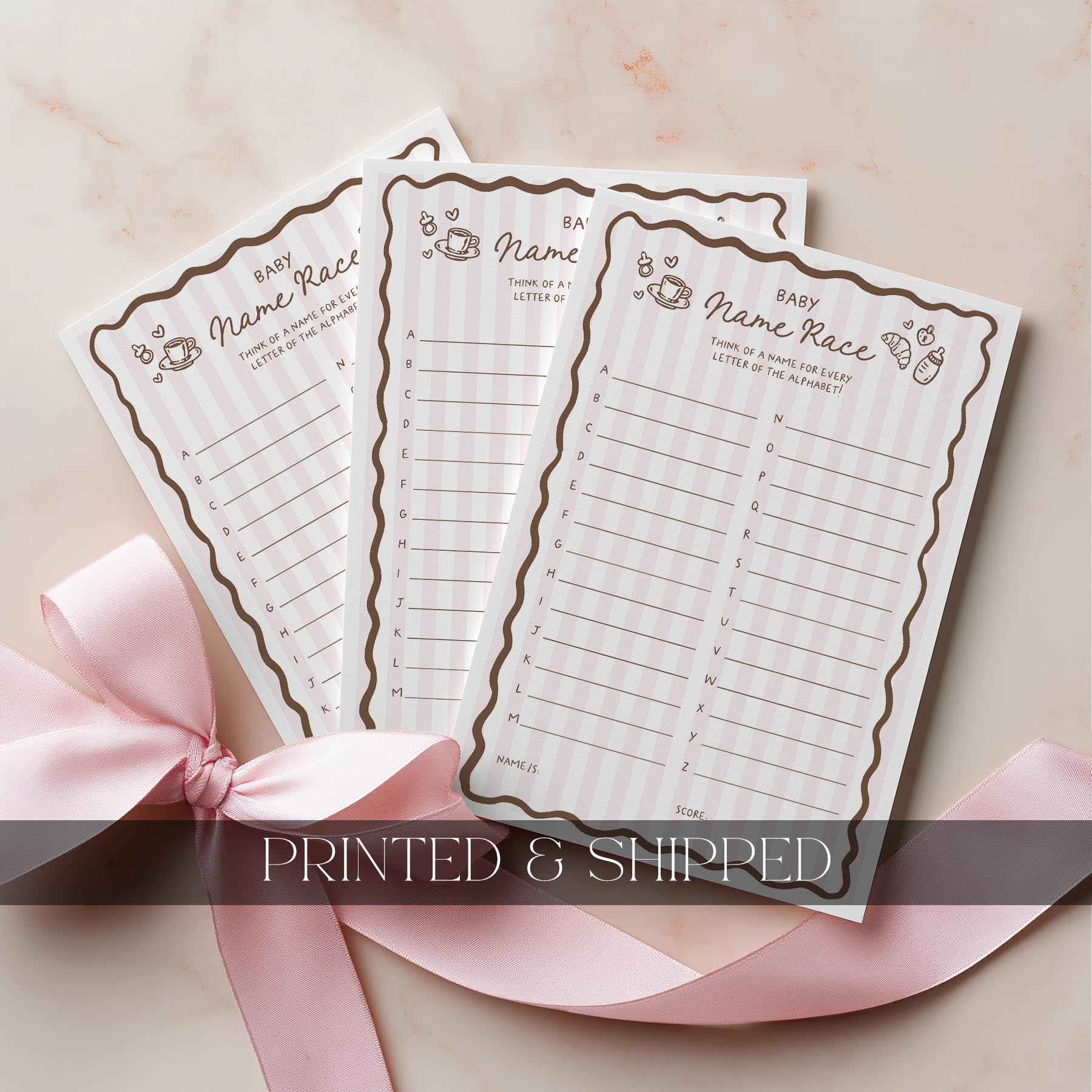 Baby shower bingo cards with a pink ribbon on a light background