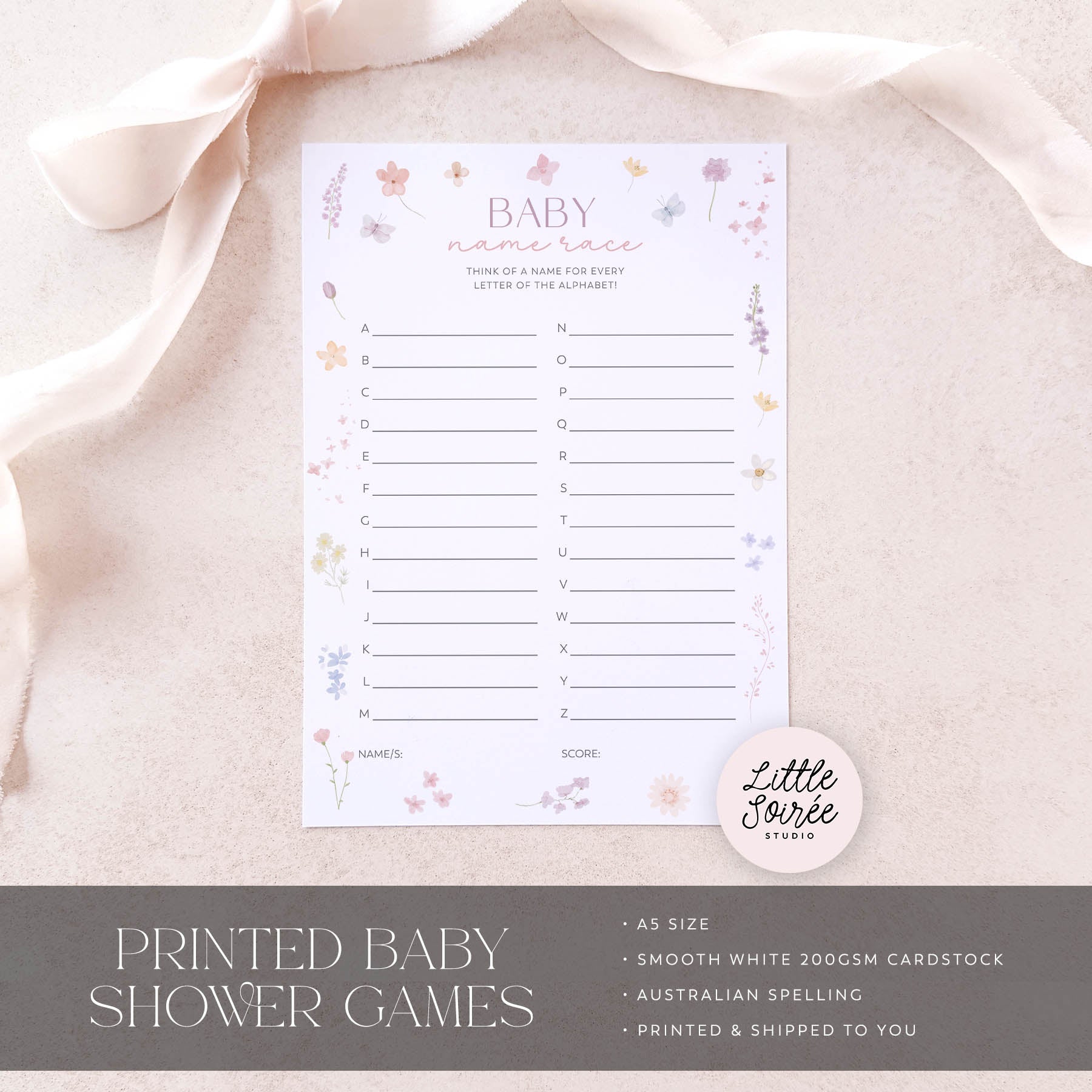 Baby shower game sheet with decorative elements on a soft fabric background