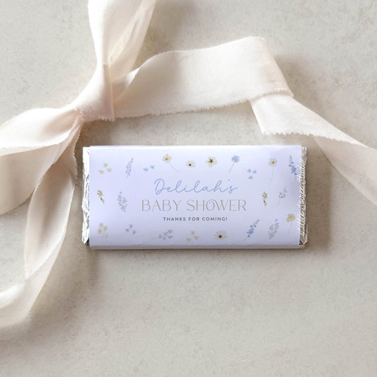 Baby shower candy bar with decorative ribbon on a light background