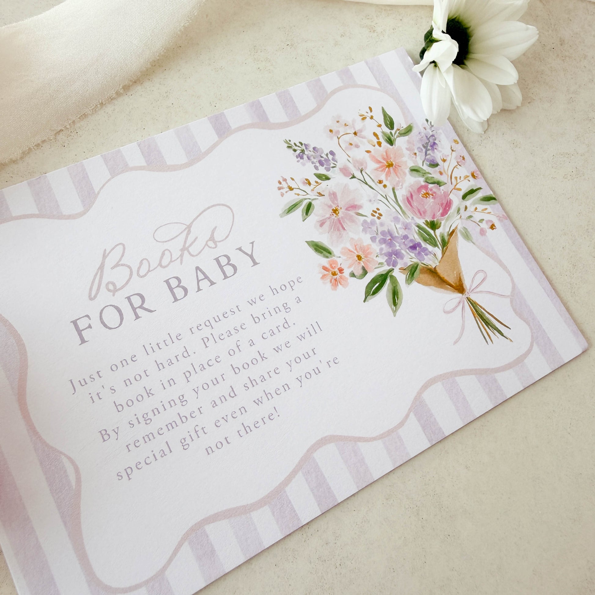 Baby shower invitation with floral design and text on a light background