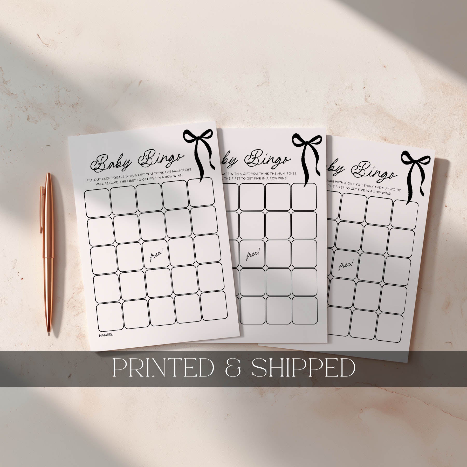 Black Bow Baby Bingo Game Cards with gold pen next to it. Printed baby shower games australia