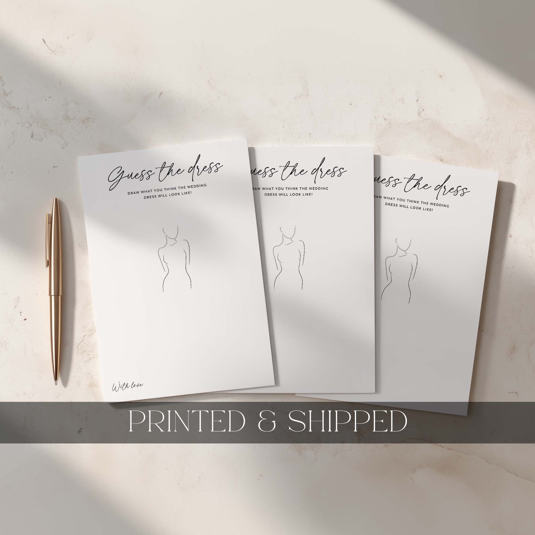Three 'Guess the dress' cards with a pen on a light surface