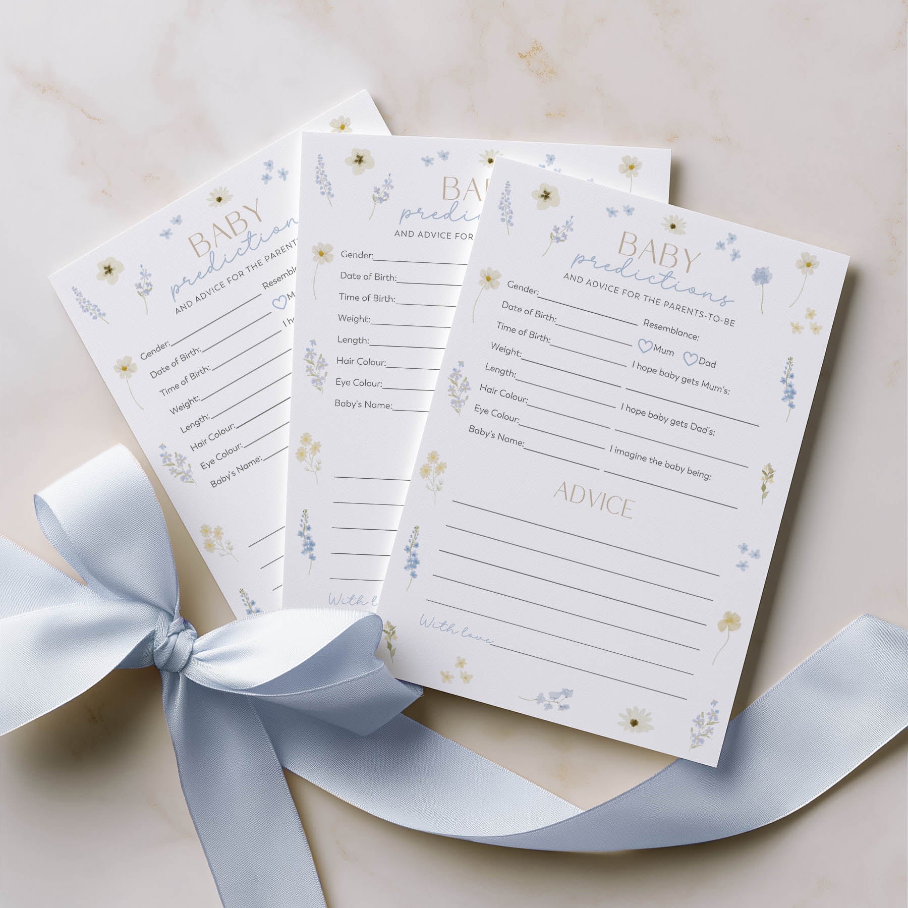 Baby shower questionnaires with decorative elements on a light background