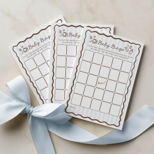 Three baby bingo cards with a decorative blue ribbon on a beige background