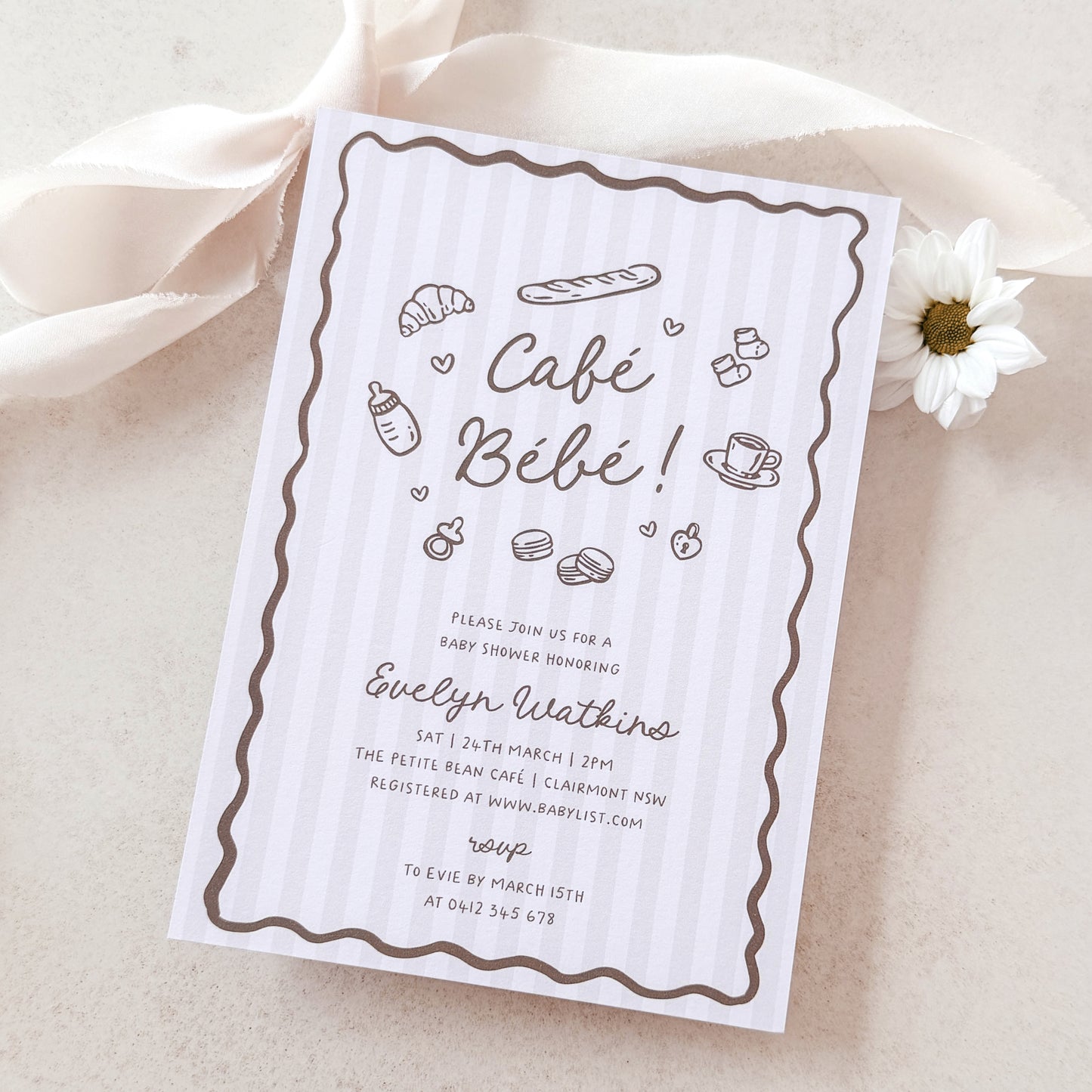 Baby shower invitation card for 'Café Bébé' with illustrations on a light background