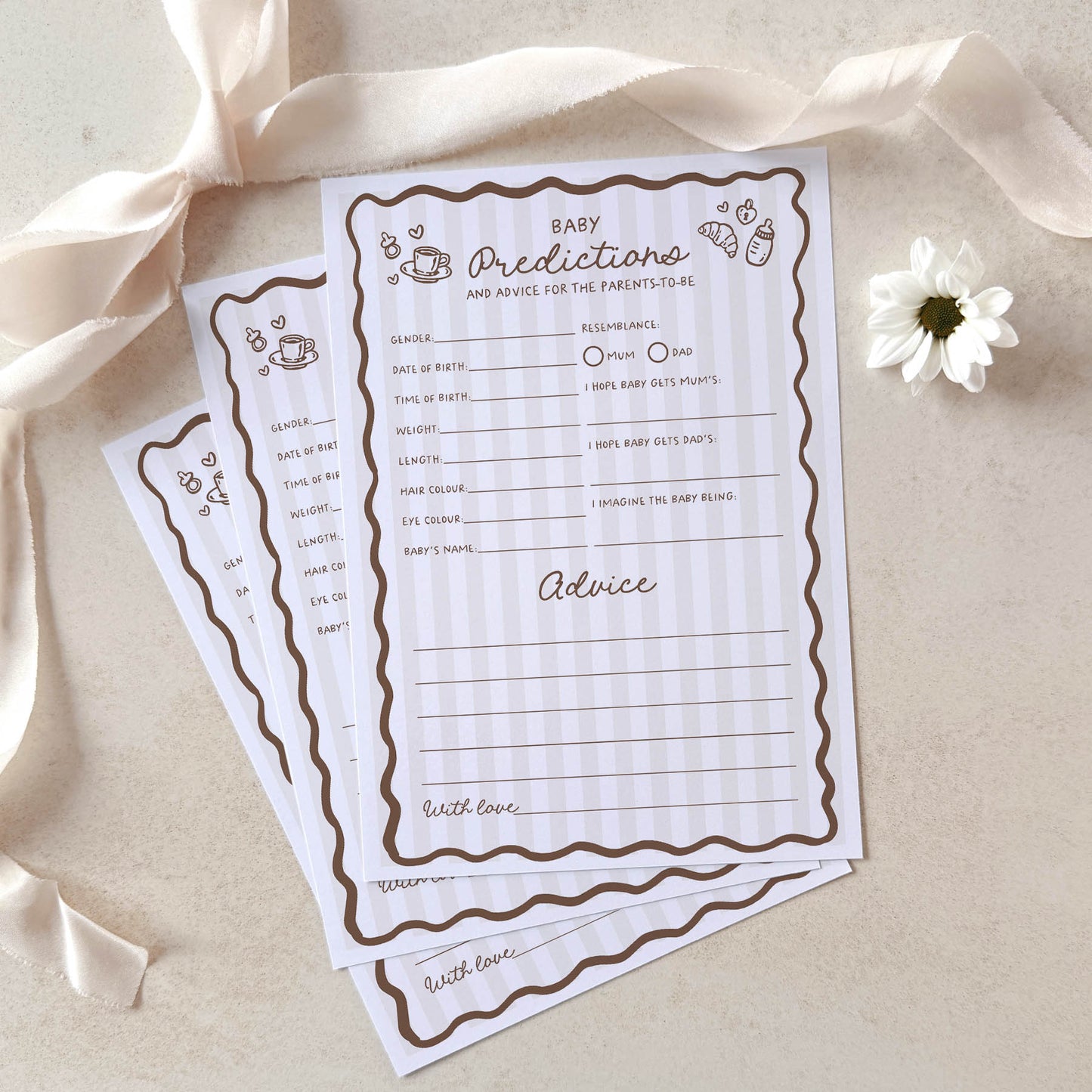 Baby predictions and advice cards with decorative ribbons and a flower on a light background