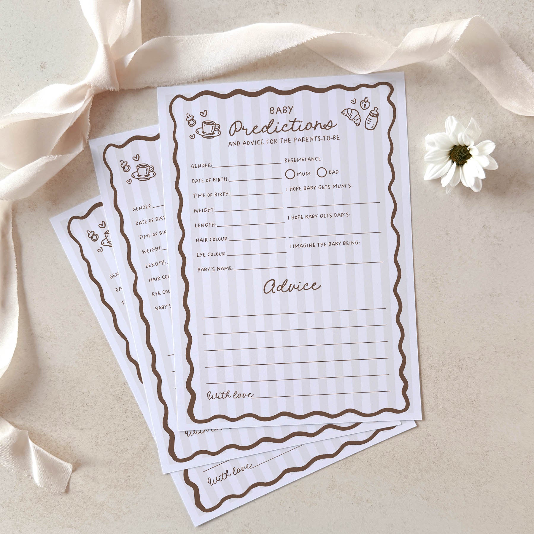 Baby predictions and advice cards with decorative ribbons and a flower on a light background