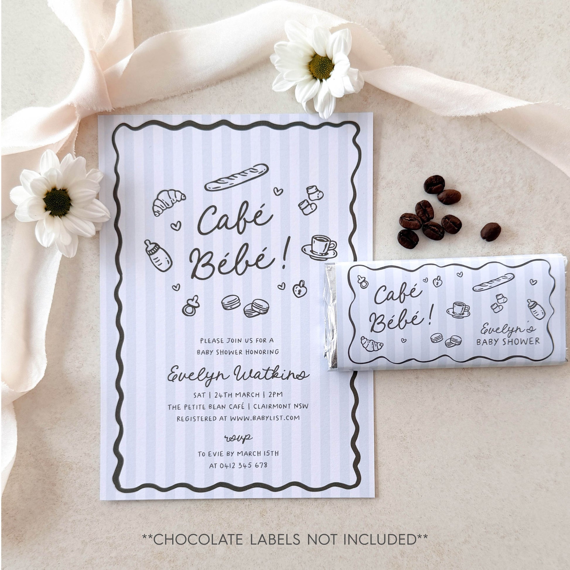 Baby shower invitation with chocolate label and ribbon on a neutral background