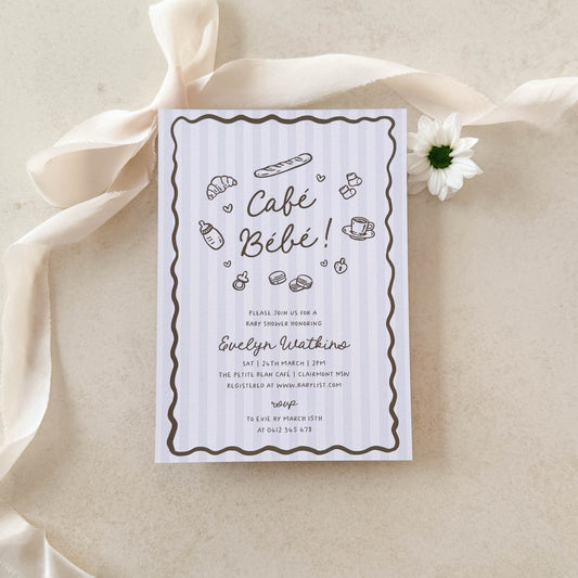 Baby shower invitation with ribbon and flower on a beige background