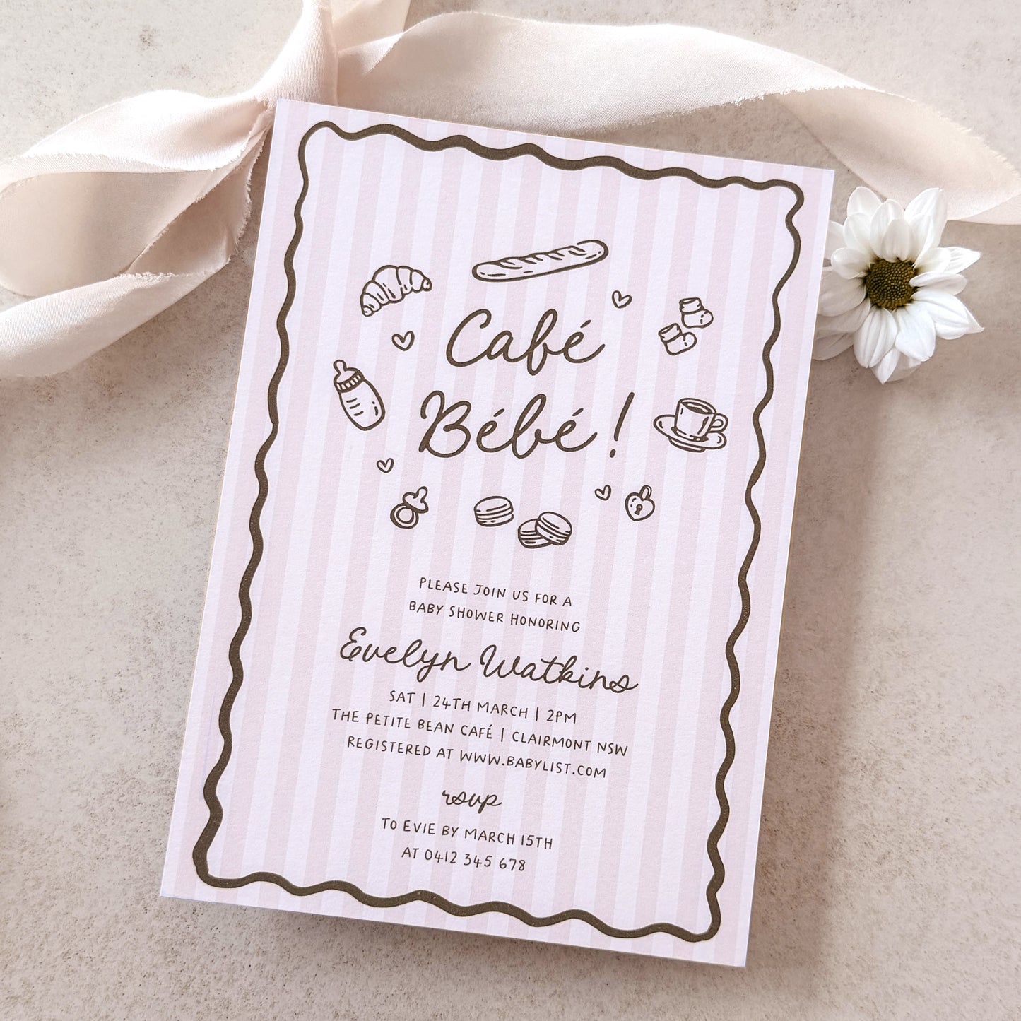 Baby shower invitation card for 'Café Bébé' with illustrations on a light background