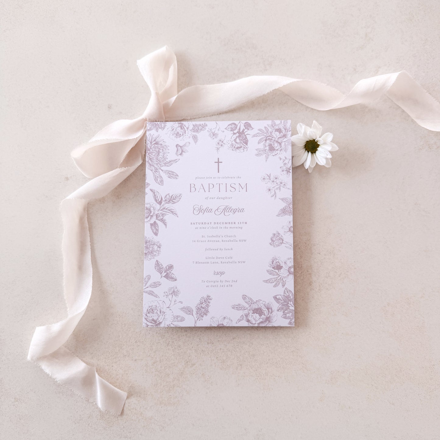 Baptism invitation with floral design on a light background with ribbon and flower