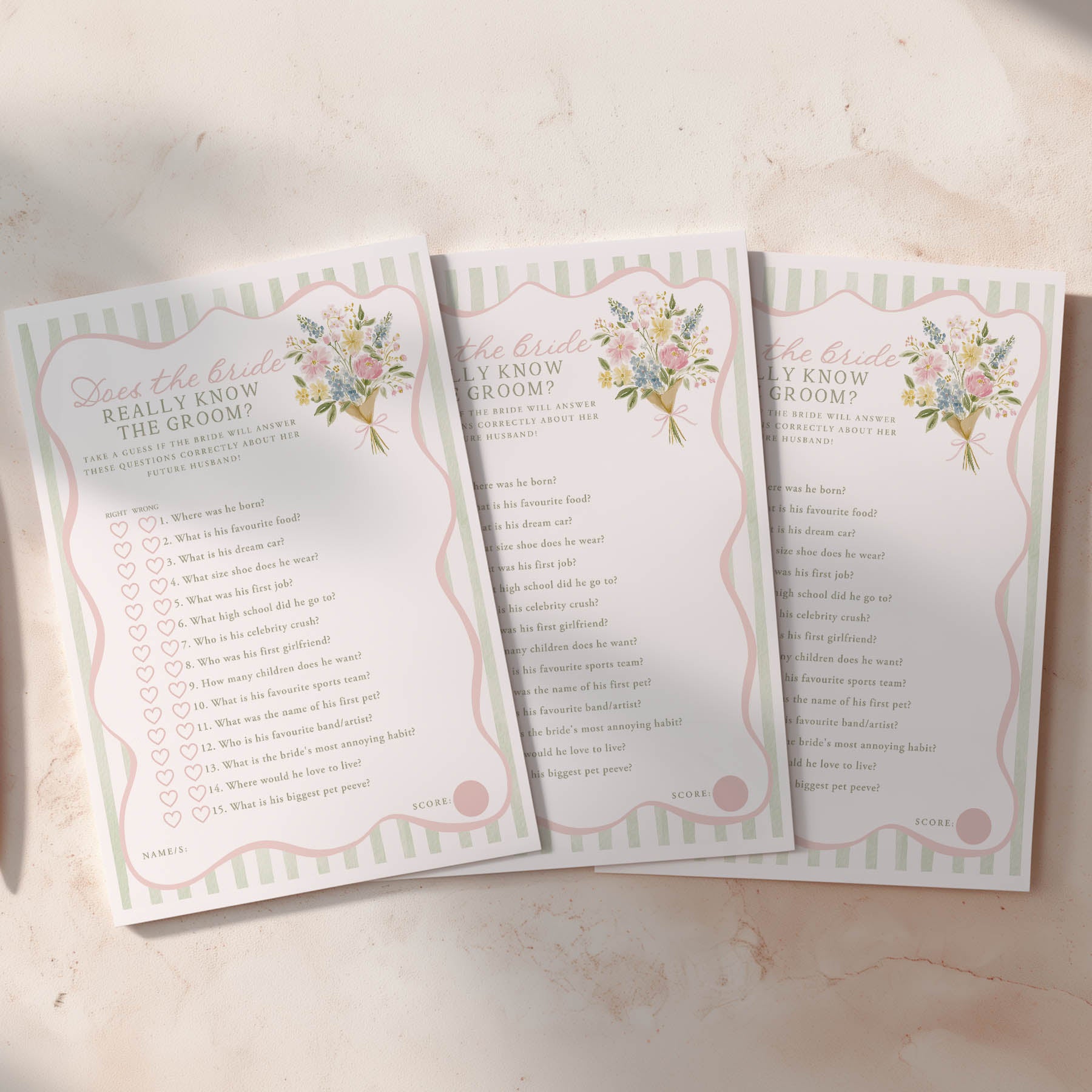 Three wedding question cards on a light surface with floral designs.