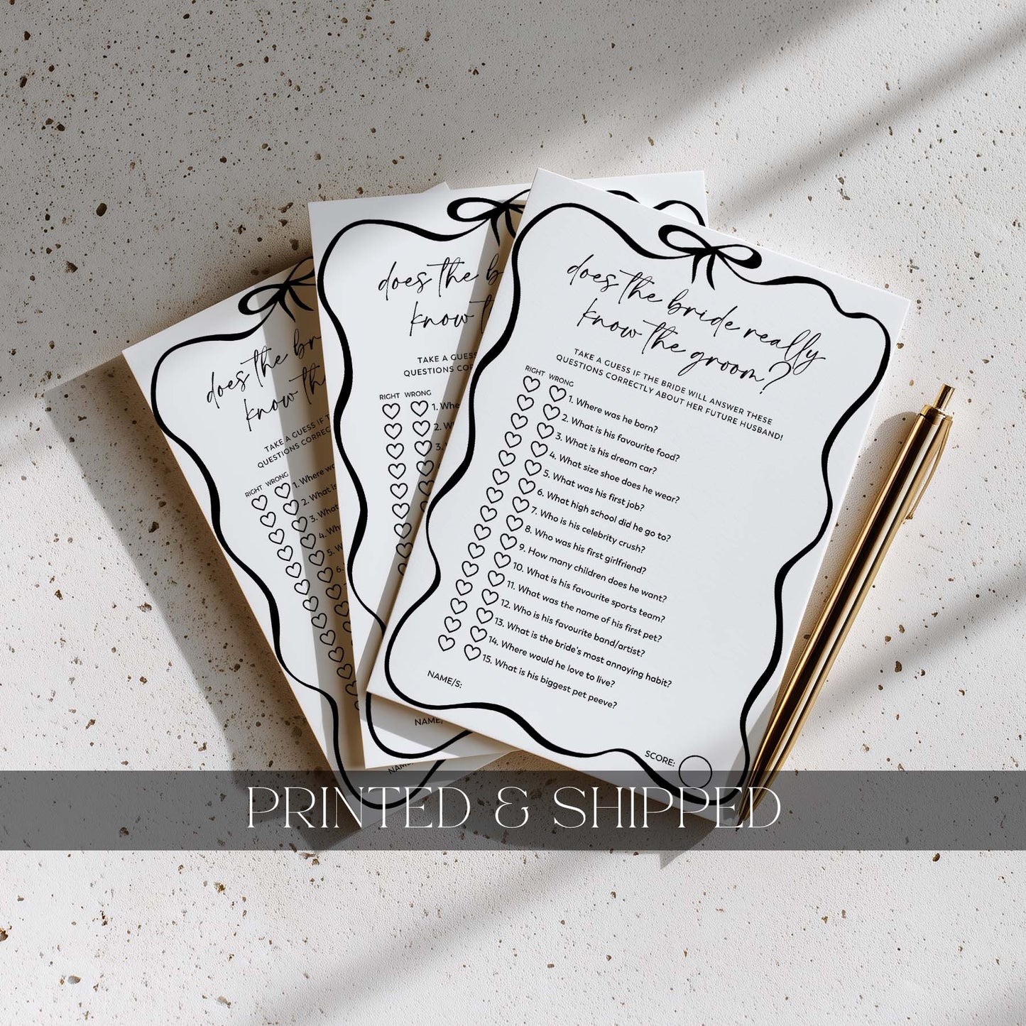 Three question cards with decorative borders on a textured surface with a pen.