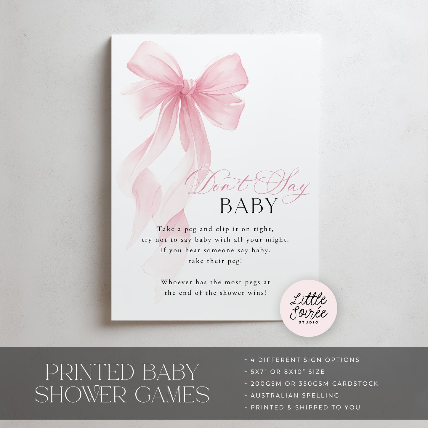 Baby shower game sign with pink bow and text on a white background