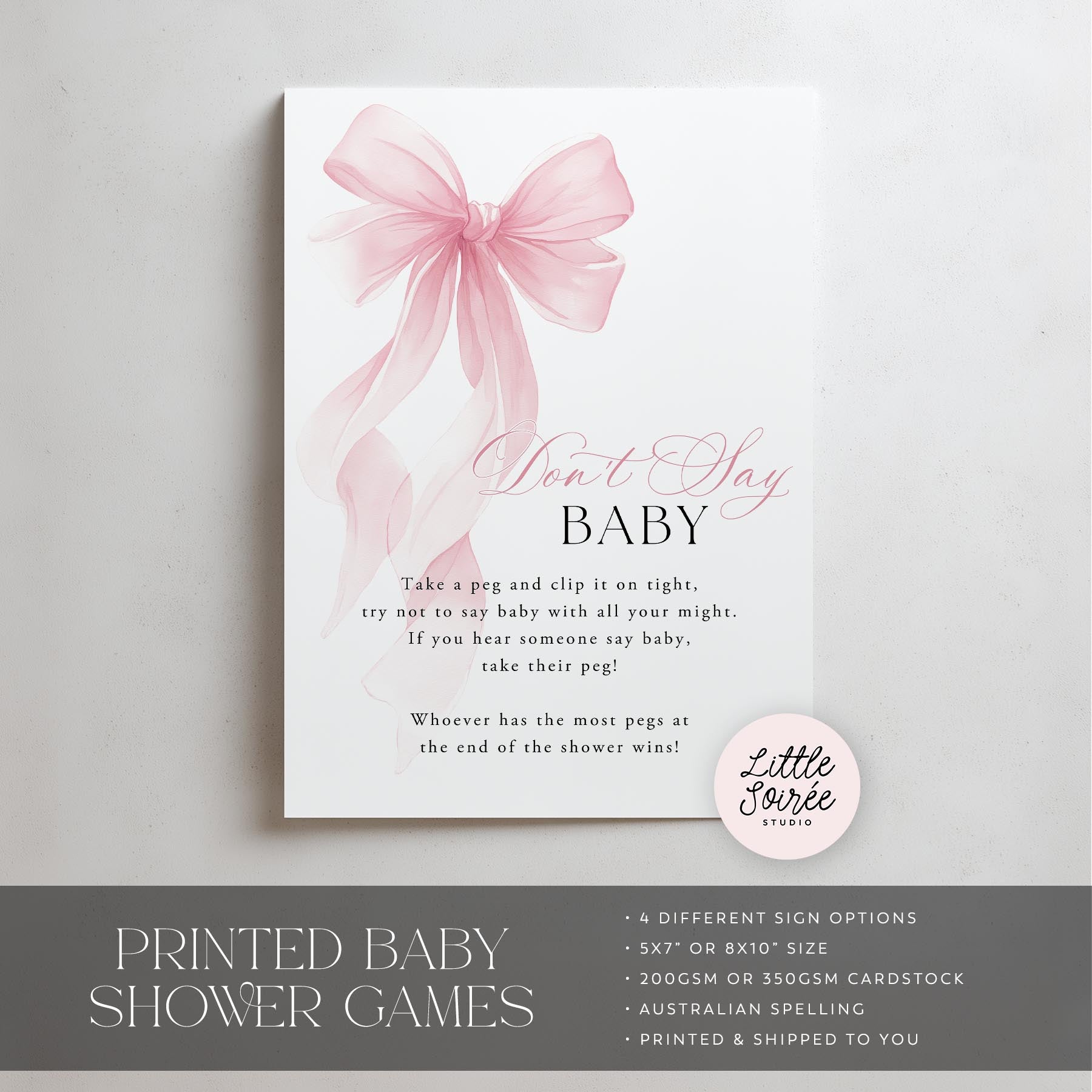 Baby shower game sign with pink bow and text on a white background