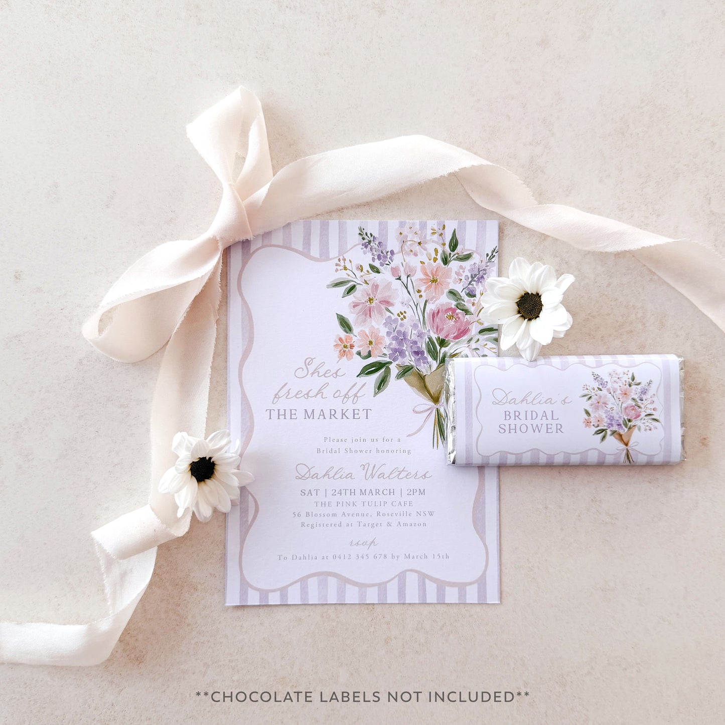 Floral invitation with a bow and white flowers on a light background
