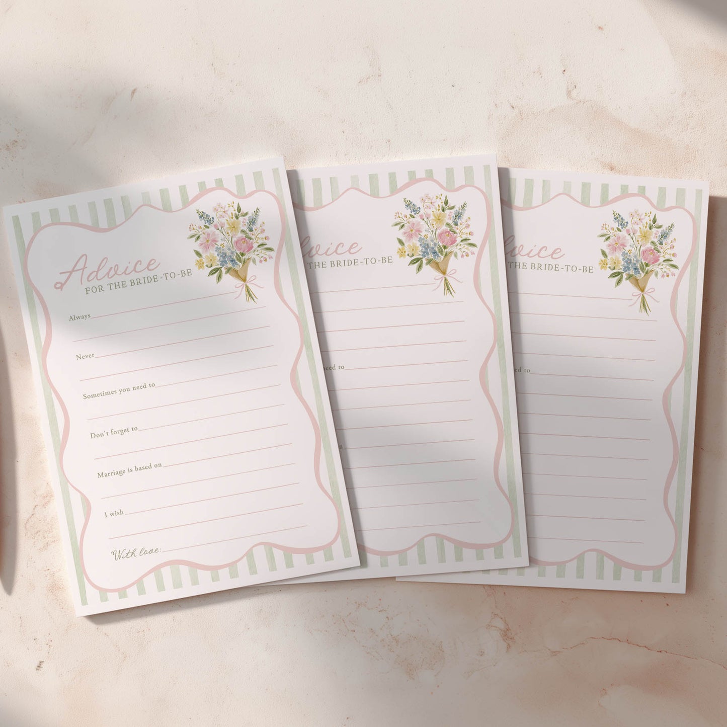 Three lined notepads with floral designs on a light background