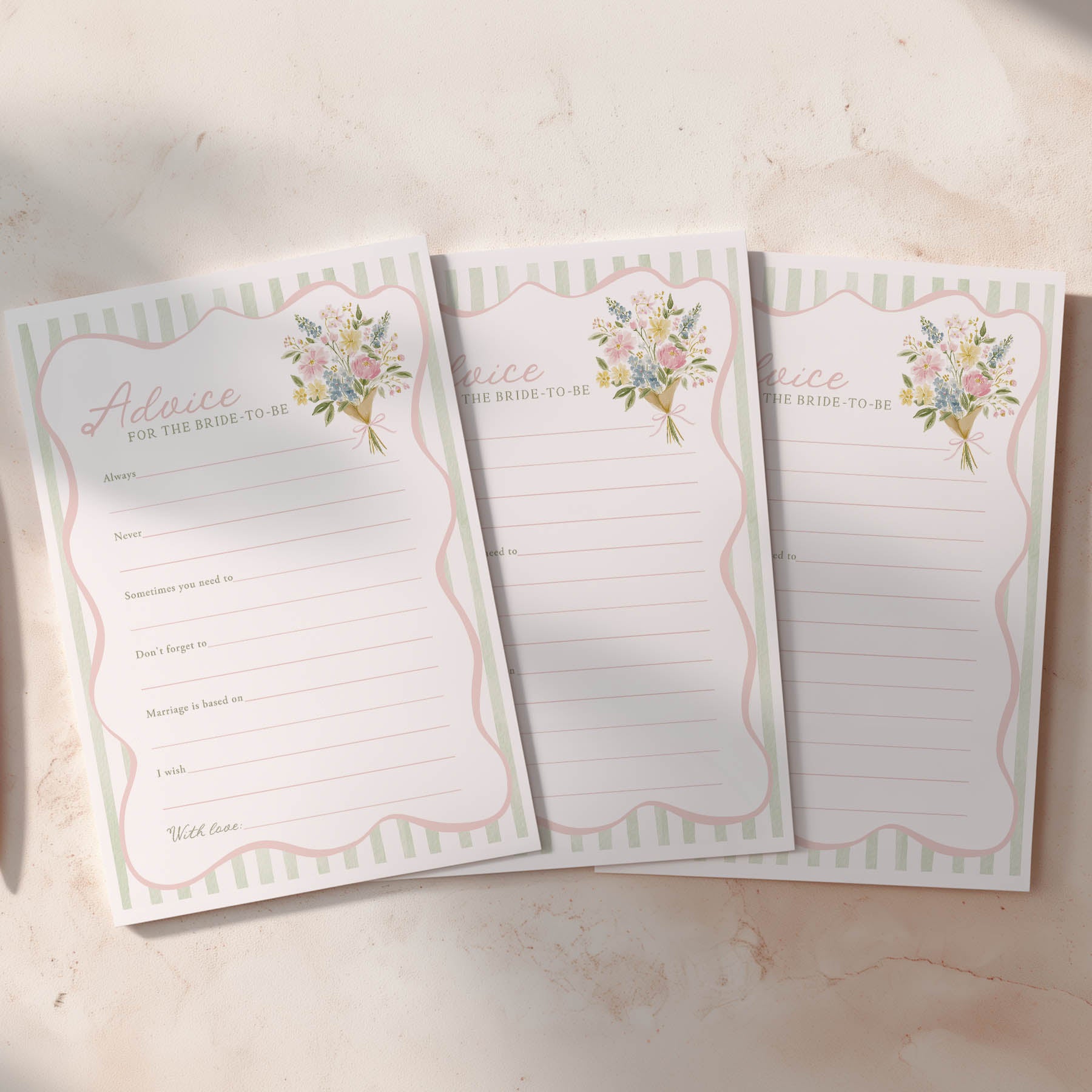 Three lined notepads with floral designs on a light background