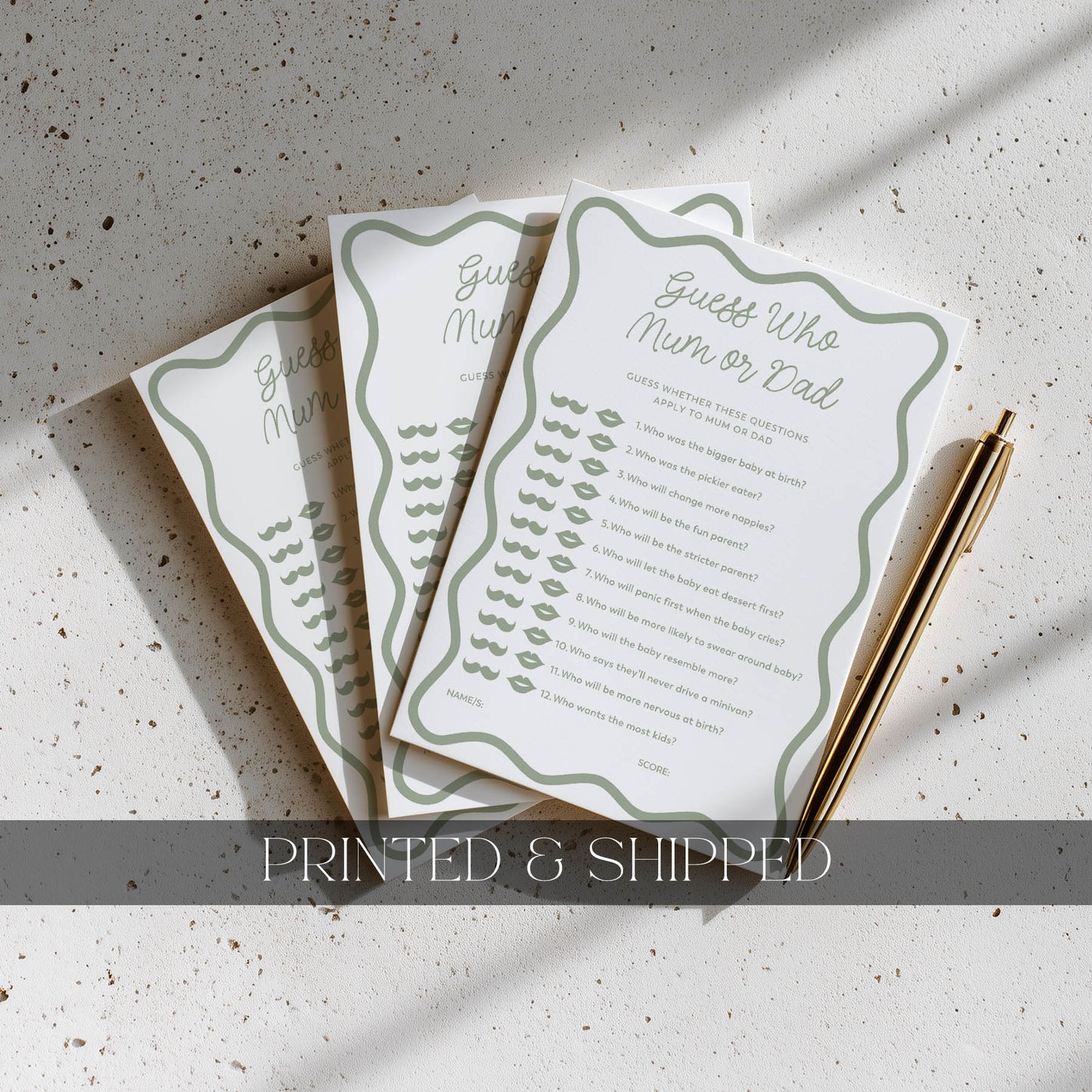 Three printed cards with text on a textured surface, accompanied by a pen.