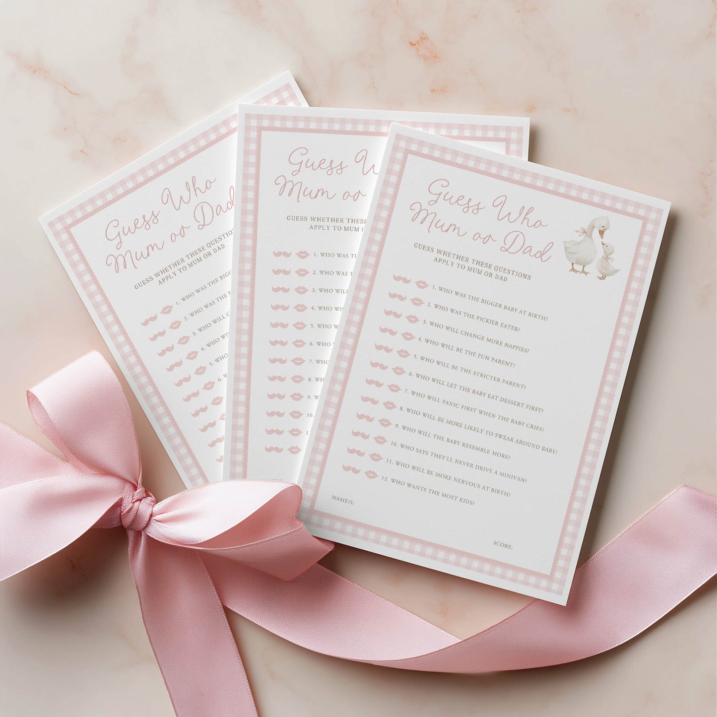 Three baby shower games with a pink ribbon on a light background