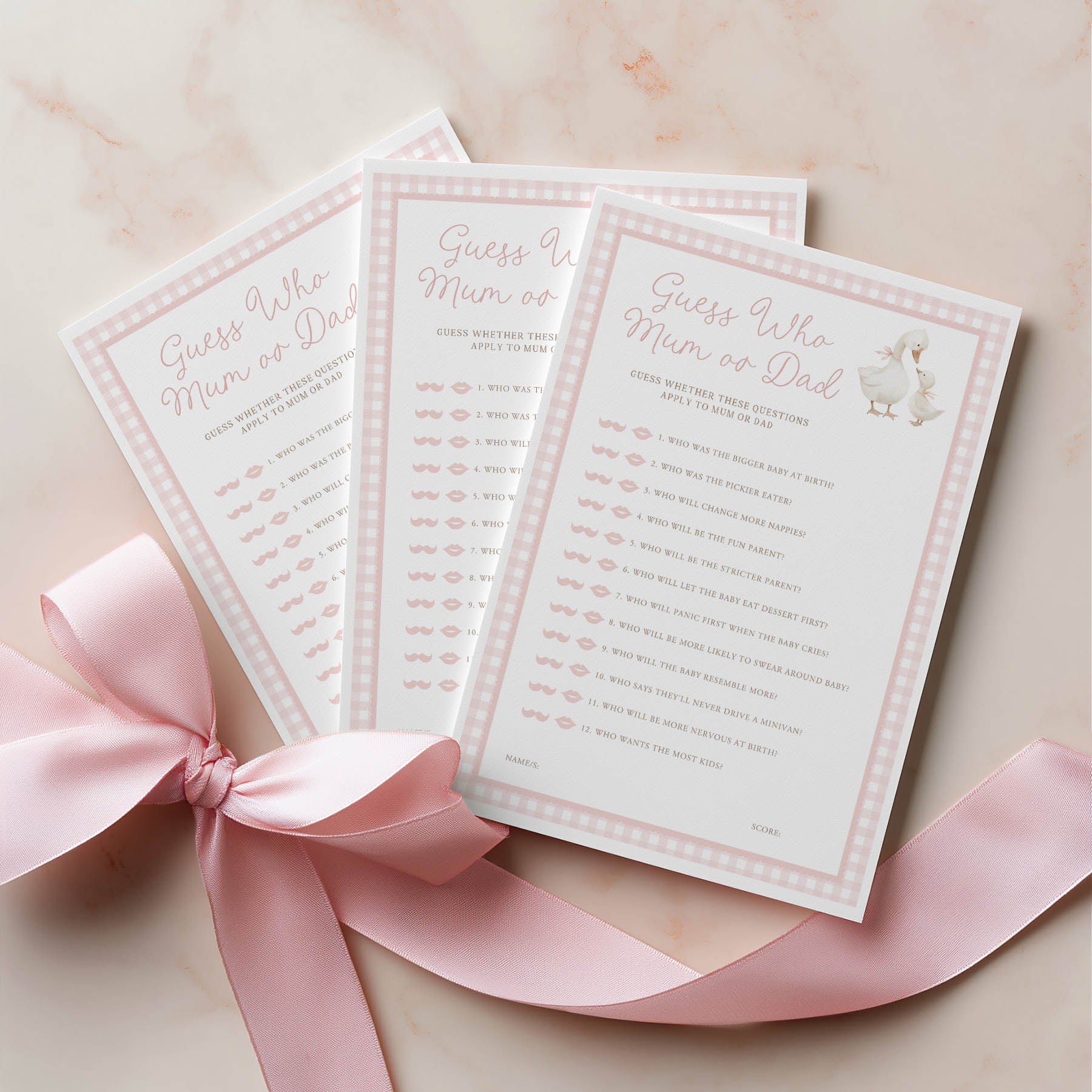 Three baby shower games with a pink ribbon on a light background