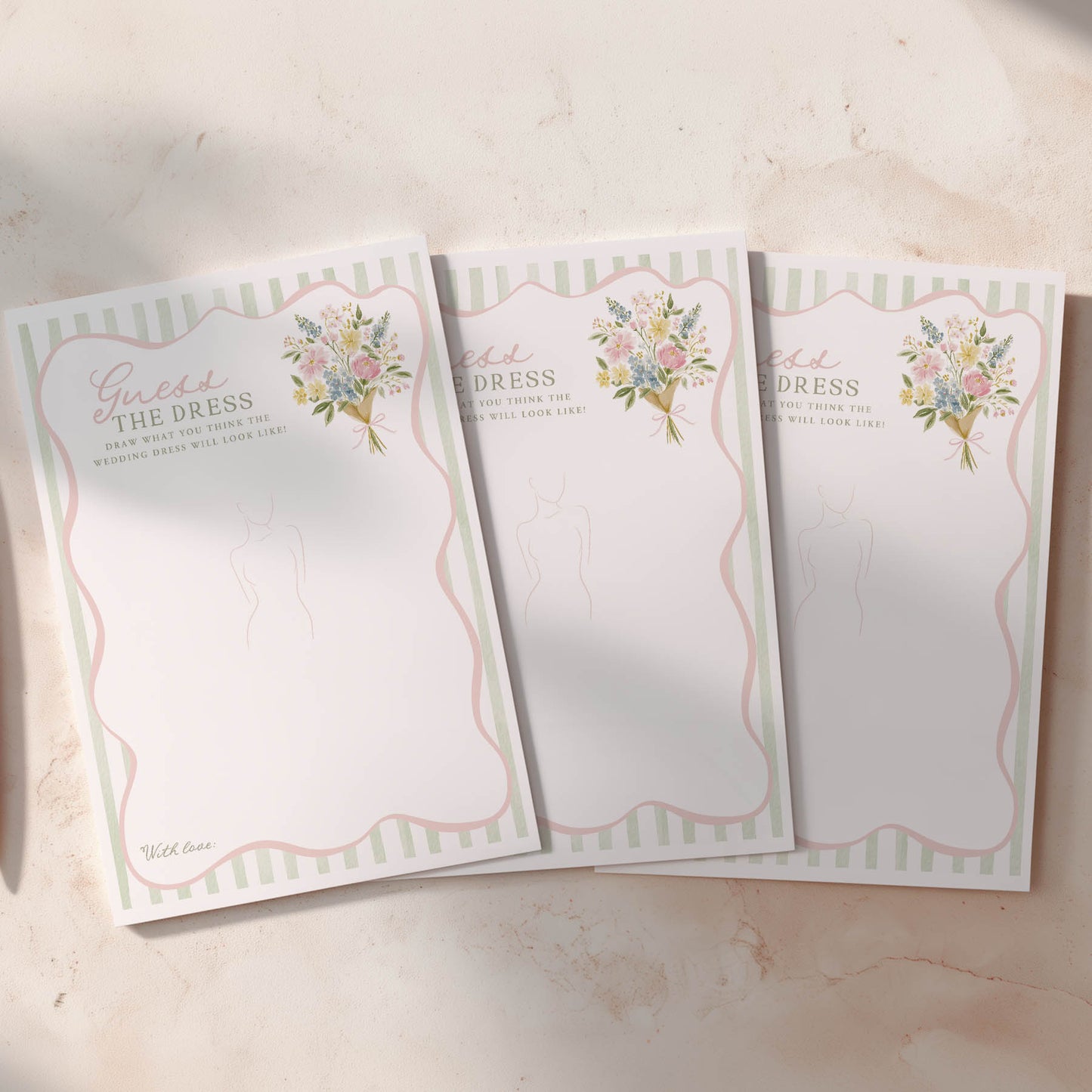 Three wedding planning notepads with floral designs on a light surface